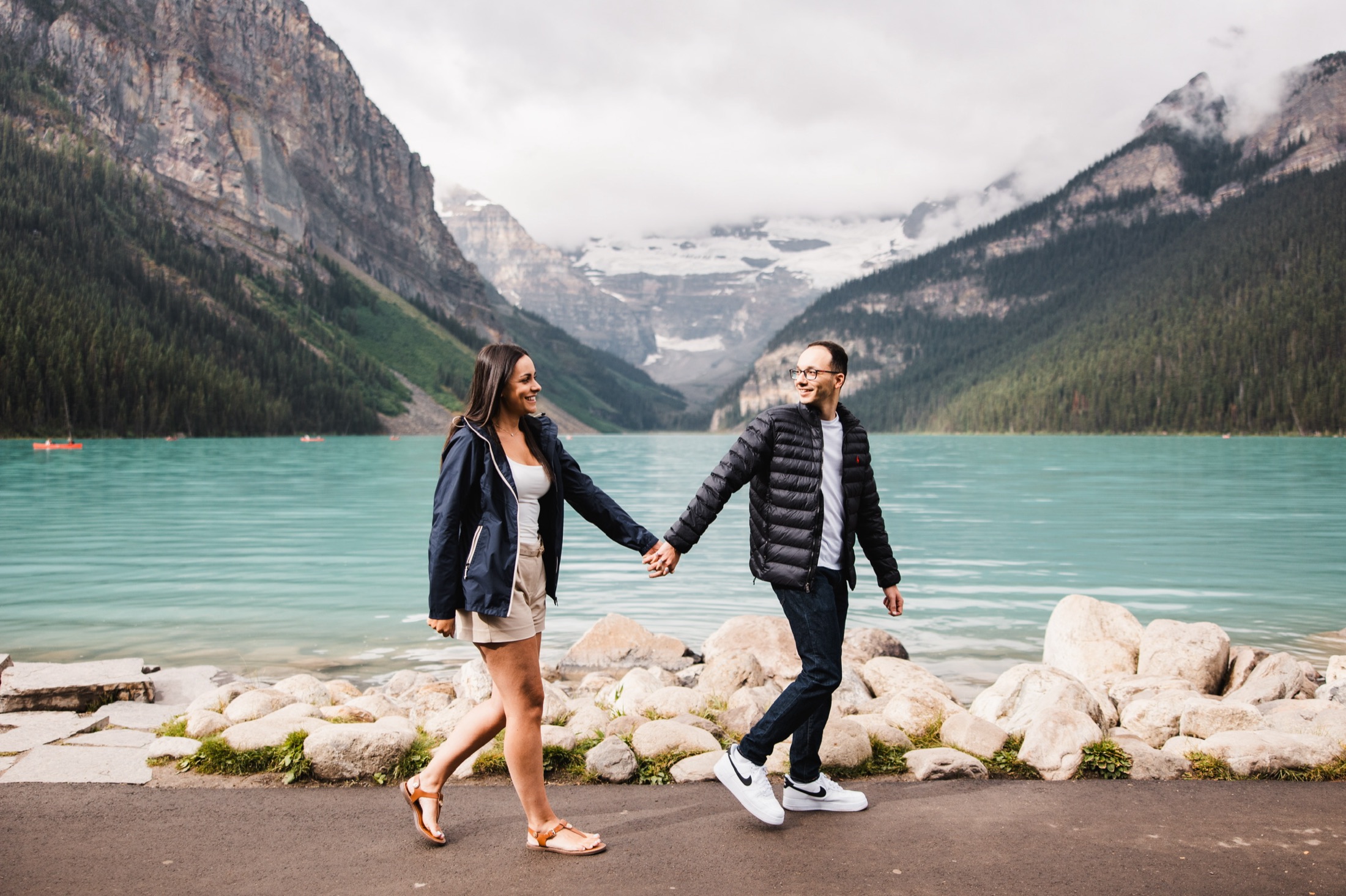 Louise and James holding hands beside Lake Louise, Banff